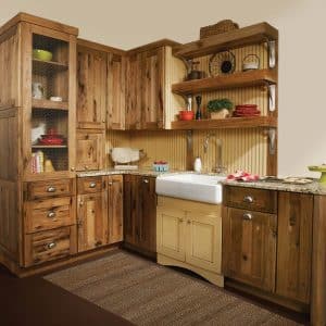 Image from Woodland Cabinetry Inspiration Gallery showing farmhouse kitchen with Rustic Farmstead cabinetry with Rustic Mission style wood doors and Reclaimed Patina finish