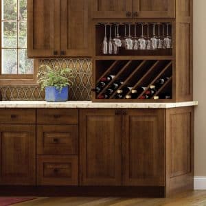 Image from Woodland Cabinetry Inspiration Gallery showing kitchen wine storage with Cherry Stained Galveston style cabinetry doors with Spice finish